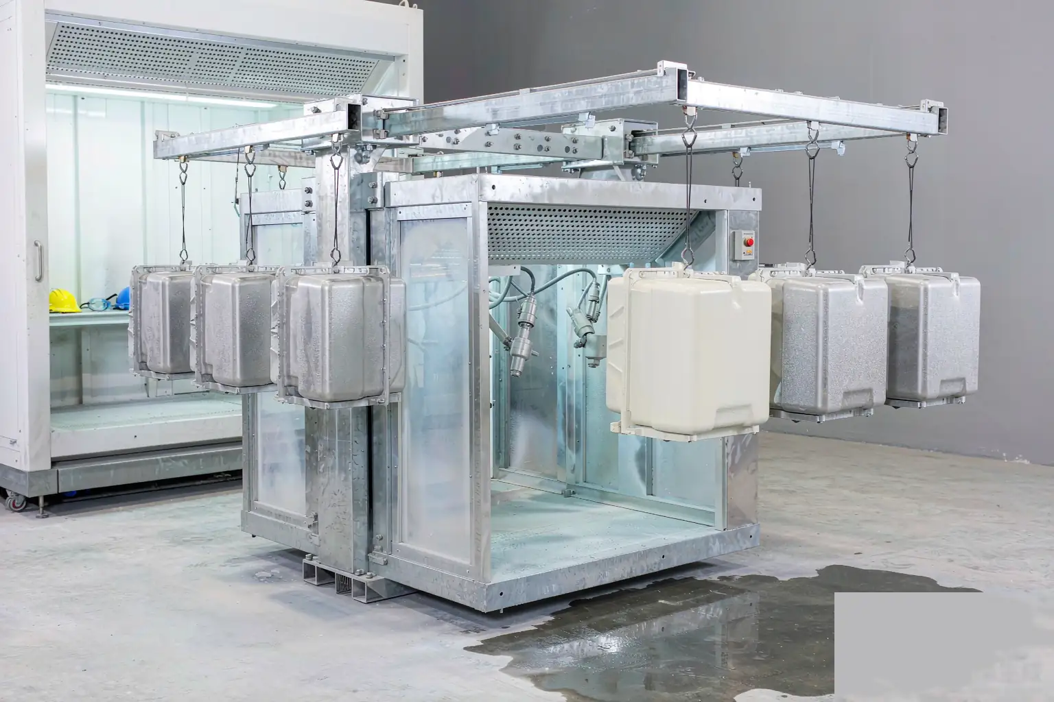 casting surface finishing coating line: aluminum housings moving through powder coating line on overhead conveyor