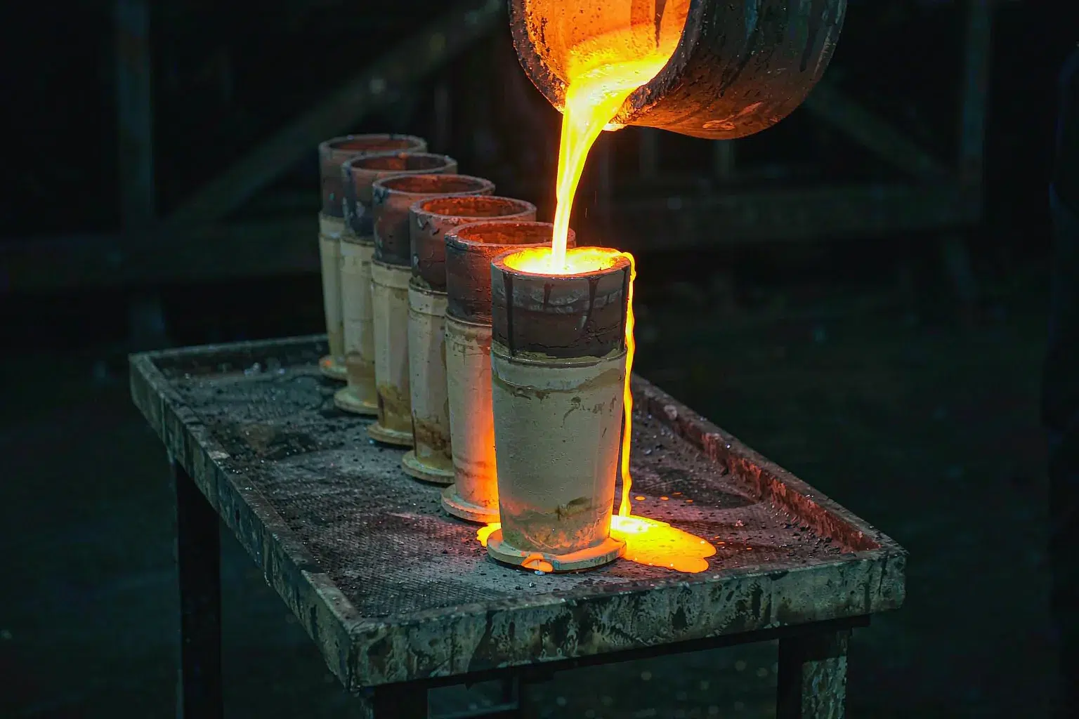 stainless steel investment casting ceramic shell molds being poured with molten metal
