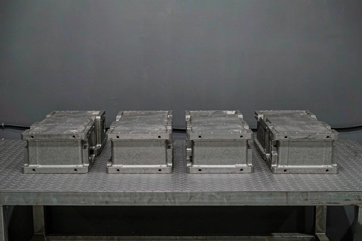shell mold casting results - finished machined cast iron housings arranged in a row on a steel bench