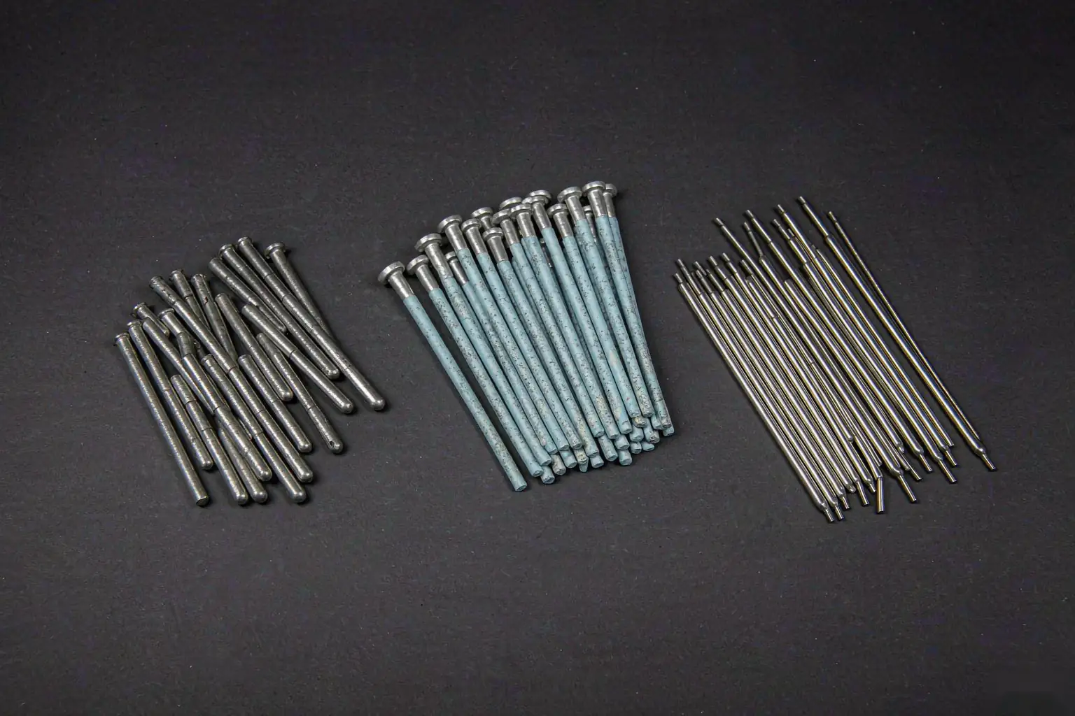 casting weld repair filler metals: nickel-iron rods and low-hydrogen steel electrodes laid out in a row on a dark steel bench